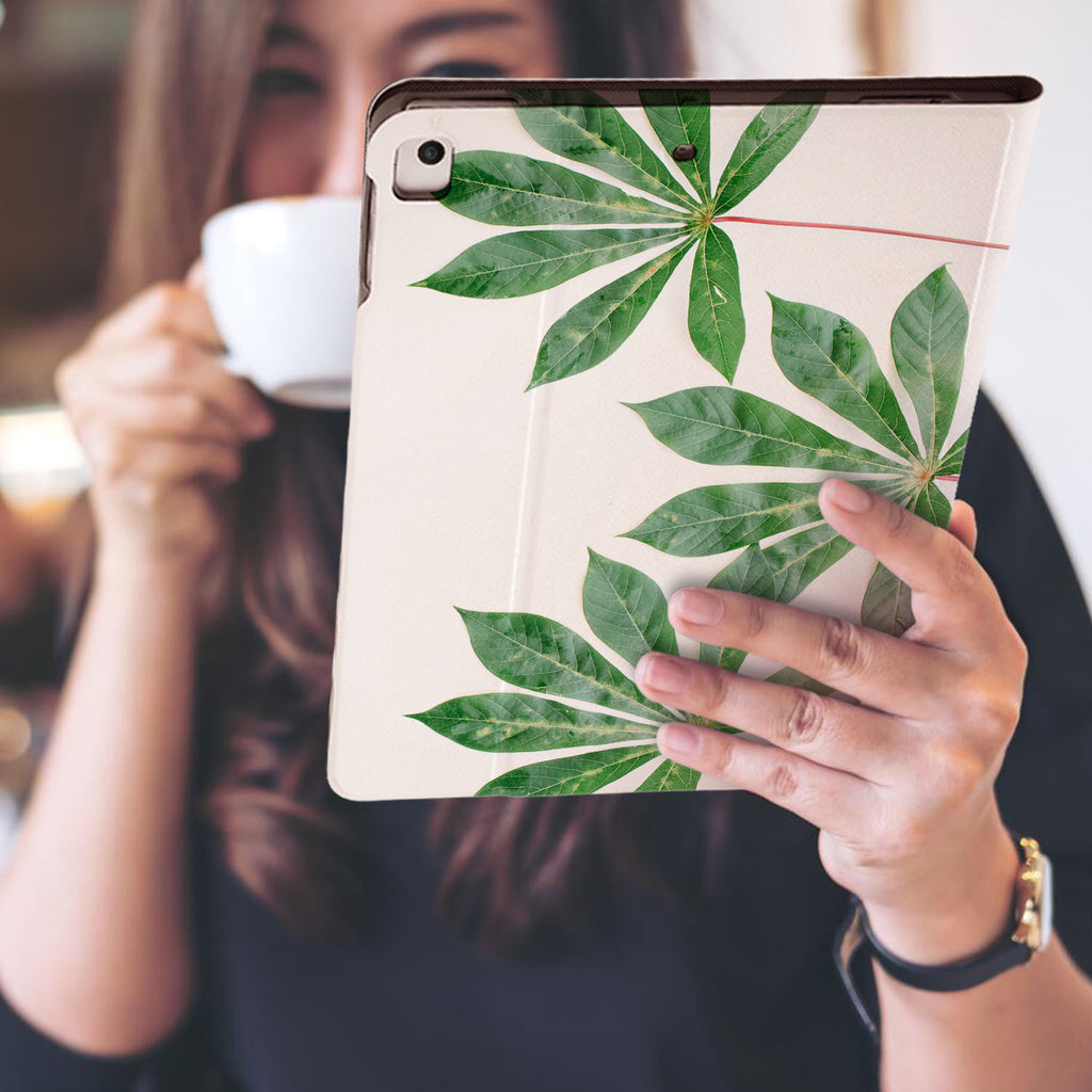 a girl is holding and viewing personalized iPad folio case with Flat Flower design