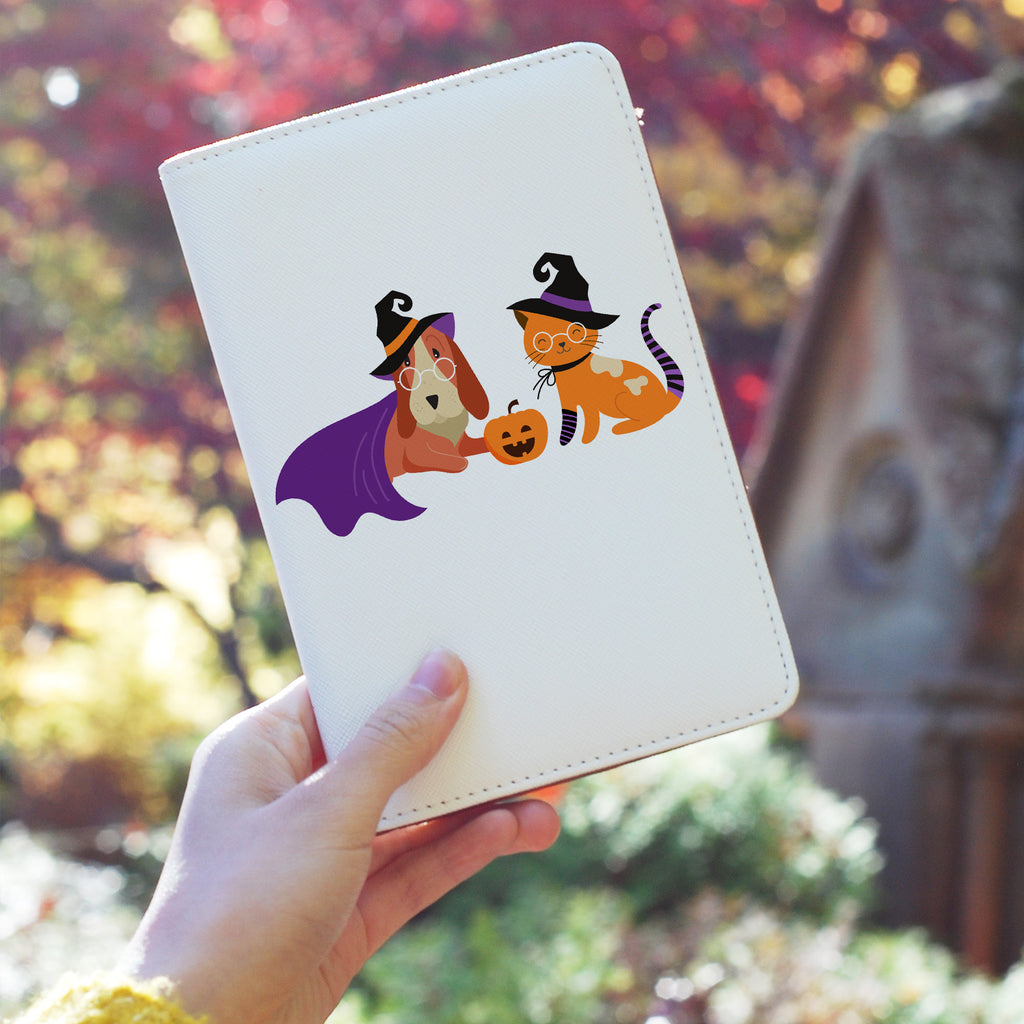 a girl holding personalized RFID blocking passport travel wallet with Halloween Pets design