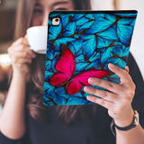 a girl is holding and viewing personalized iPad folio case with Butterfly design 
