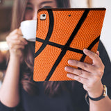 a girl is holding and viewing personalized iPad folio case with Sport design 