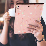 a girl is holding and viewing personalized iPad folio case with Baby design 