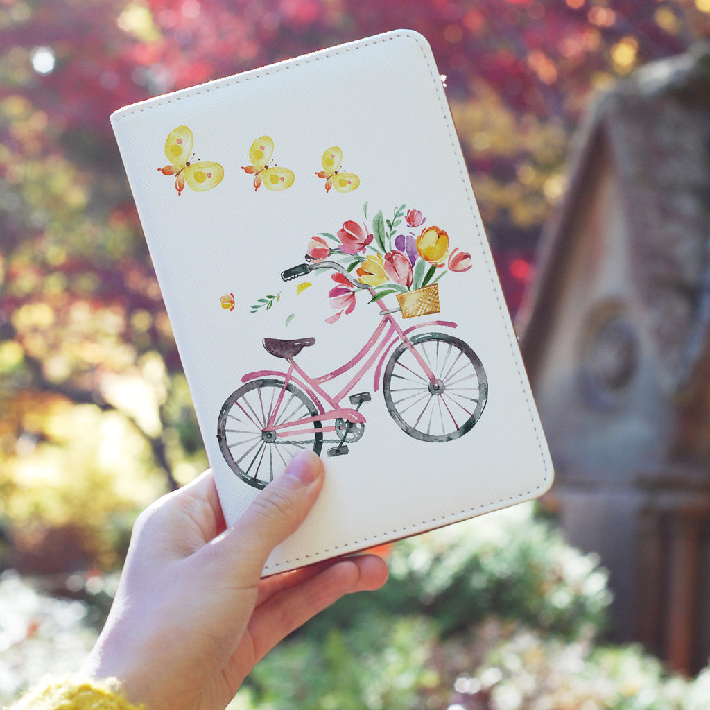 a girl holding personalized RFID blocking passport travel wallet with Springtime design