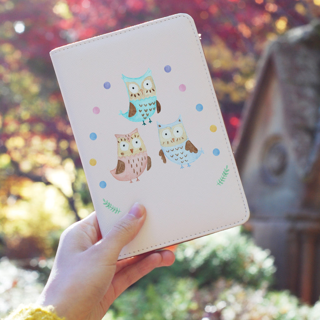 a girl holding personalized RFID blocking passport travel wallet with Happy Owls design