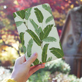 a girl holding personalized RFID blocking passport travel wallet with Green Leaves design