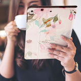 a girl is holding and viewing personalized iPad folio case with Flamingo design 